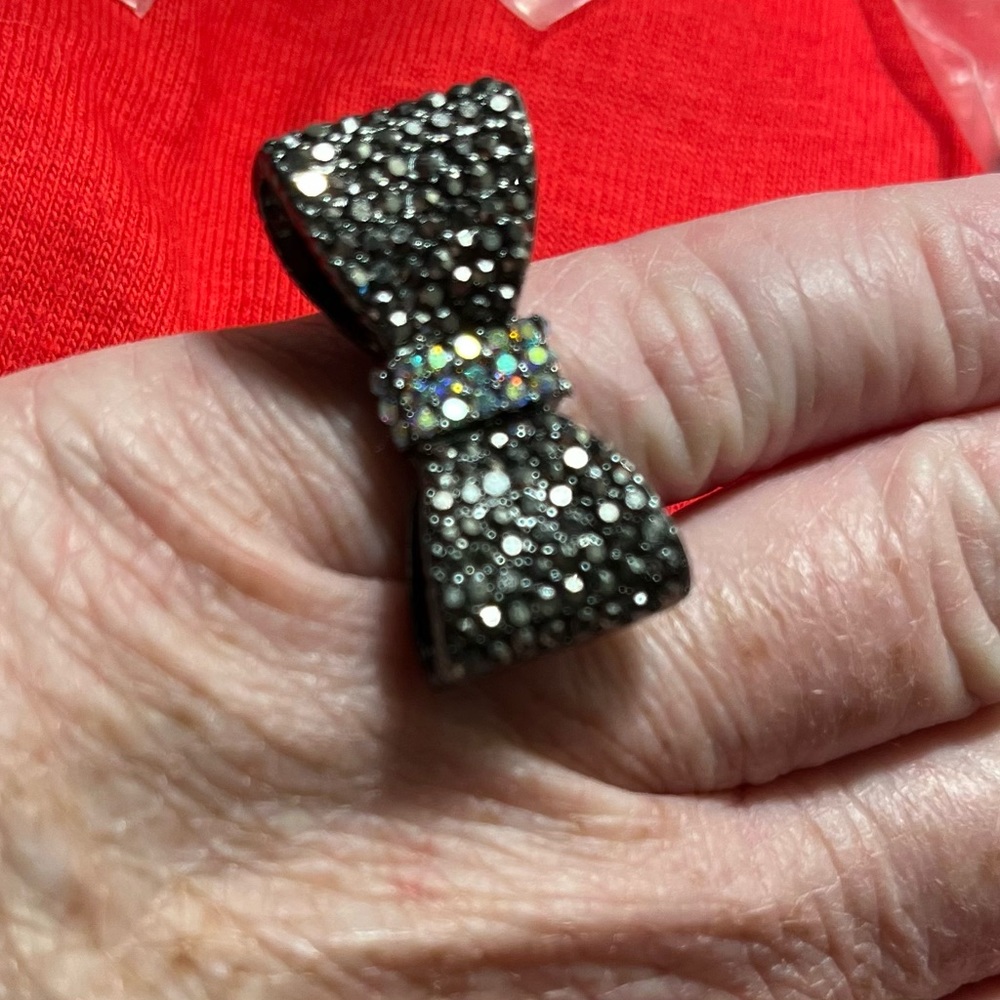 Very pretty Bow ring with a little bling. Band is adjustable expands as needed
